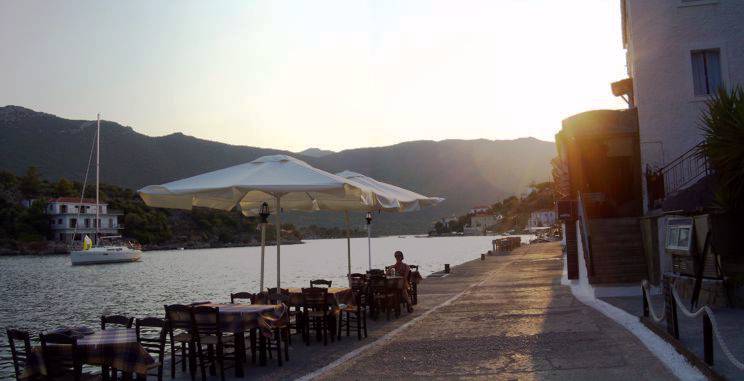 Sailing holiday locations in Greece: Relaxing on the quayside, Y&eacute;rakas, as the sun sets behond the Pelopopnnese mainland